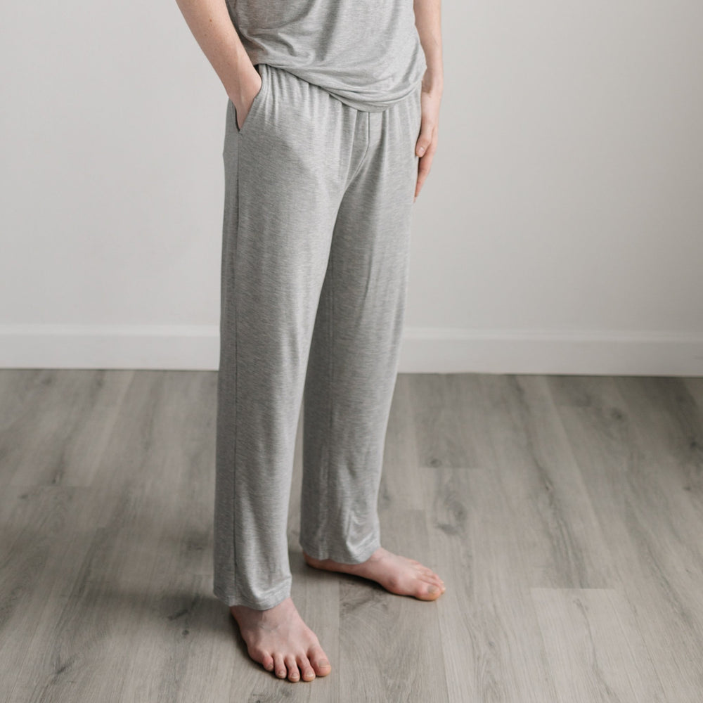 Image of male model wearing solid heather gray pajama pants. 