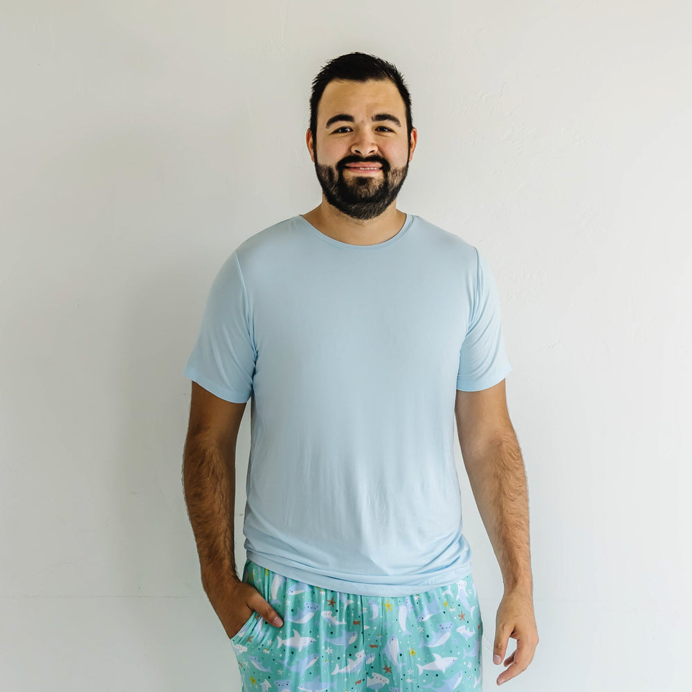 Image of male model wearing a solid aqua short sleeve pajama top that coordinates perfectly with our Shark Soiree print.
