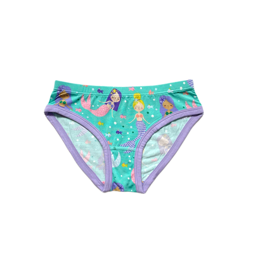 Click to see full screen - Flat lay image of girls brief underwear in Mermaid Magic print. This adorable aquatic print features magical mermaids and friendly fish on an aqua background with a wisteria trim. 