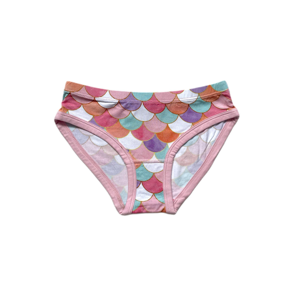 Flat lay image of girls brief underwear in Mermaid Scales print. This whimsical print features shimmering mermaid scales in pastel colors