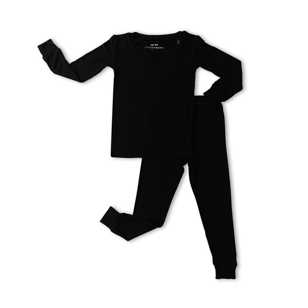 Flat lay image of a two-piece pajama set in solid black. 