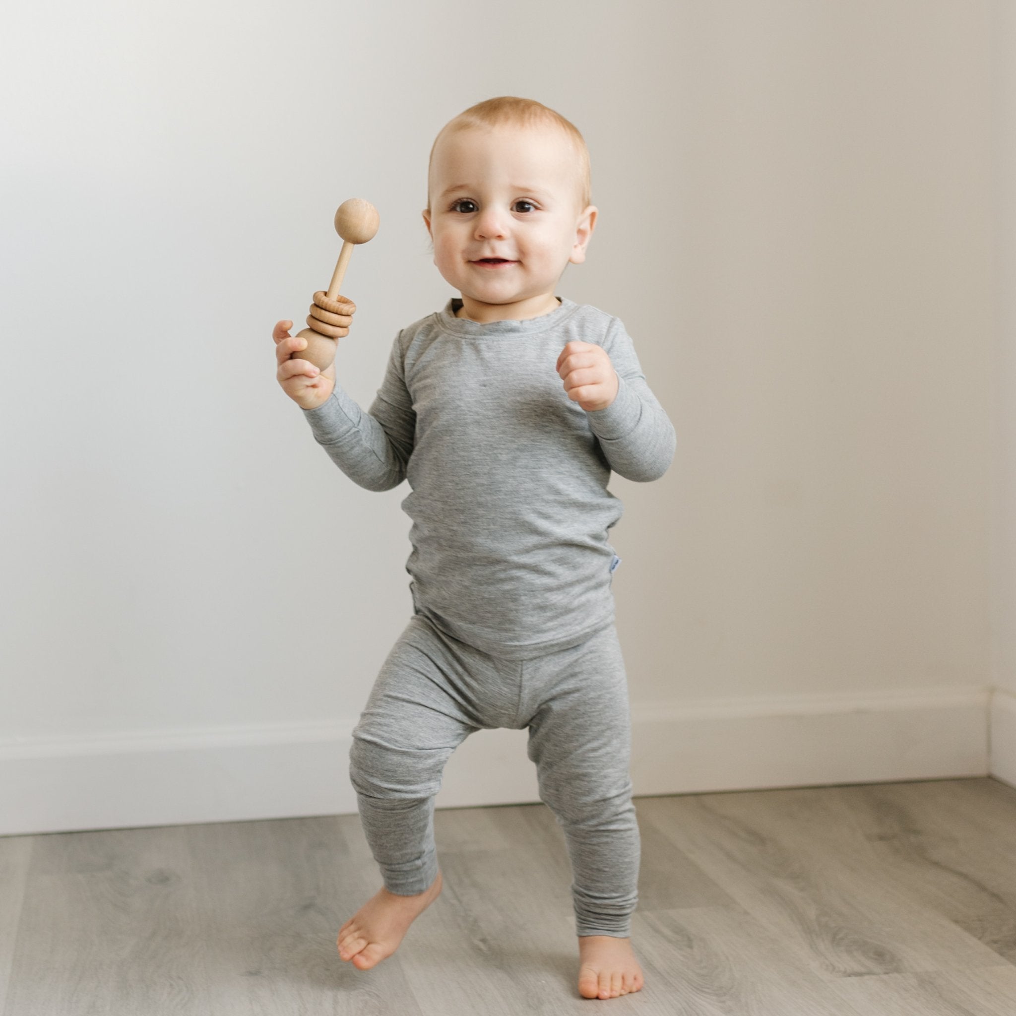 Walking toddler wearing the Heather Gray Two-Piece Pajama Set