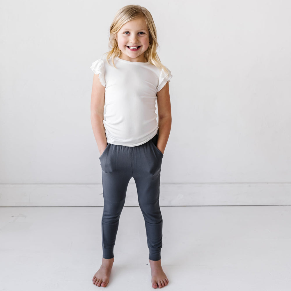 Click to see full screen - Child in White Flutter Sleeve Tee and Charcoal Joggers