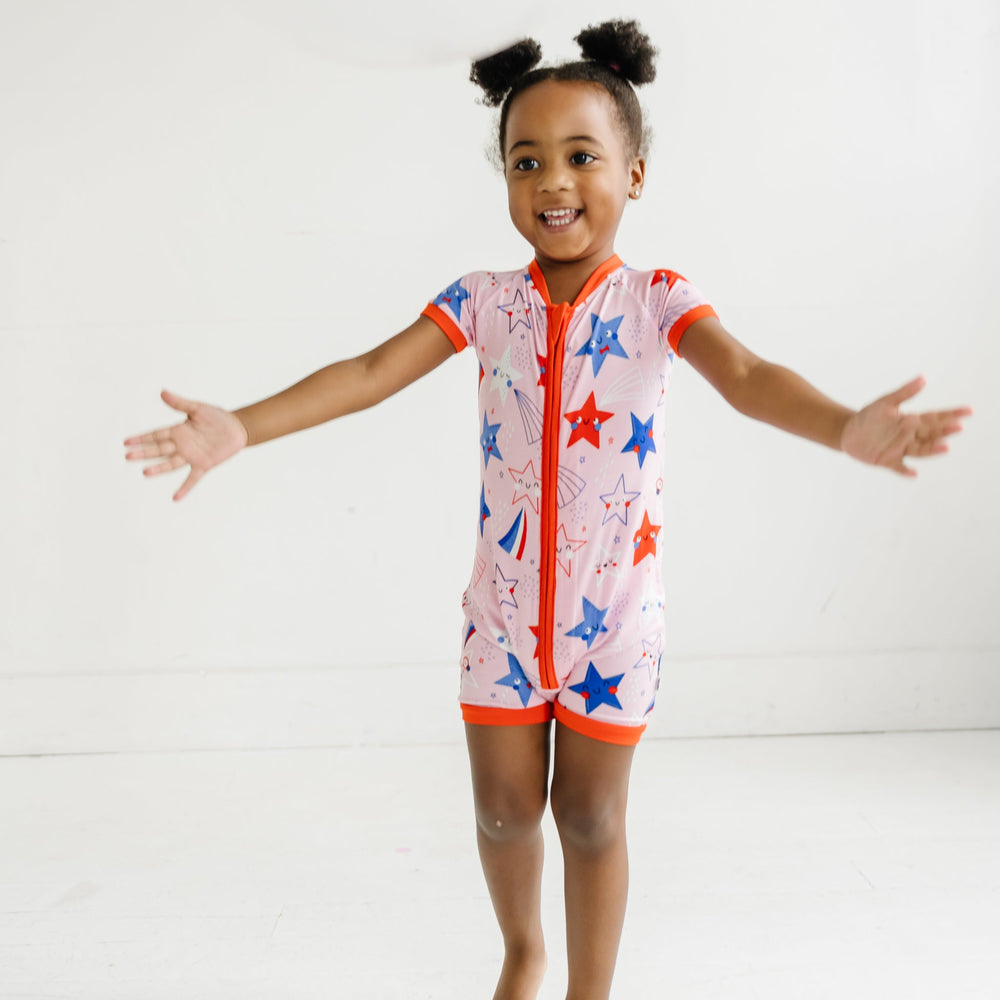 Child wearing a Pink Stars and Stripes printed shorty romper