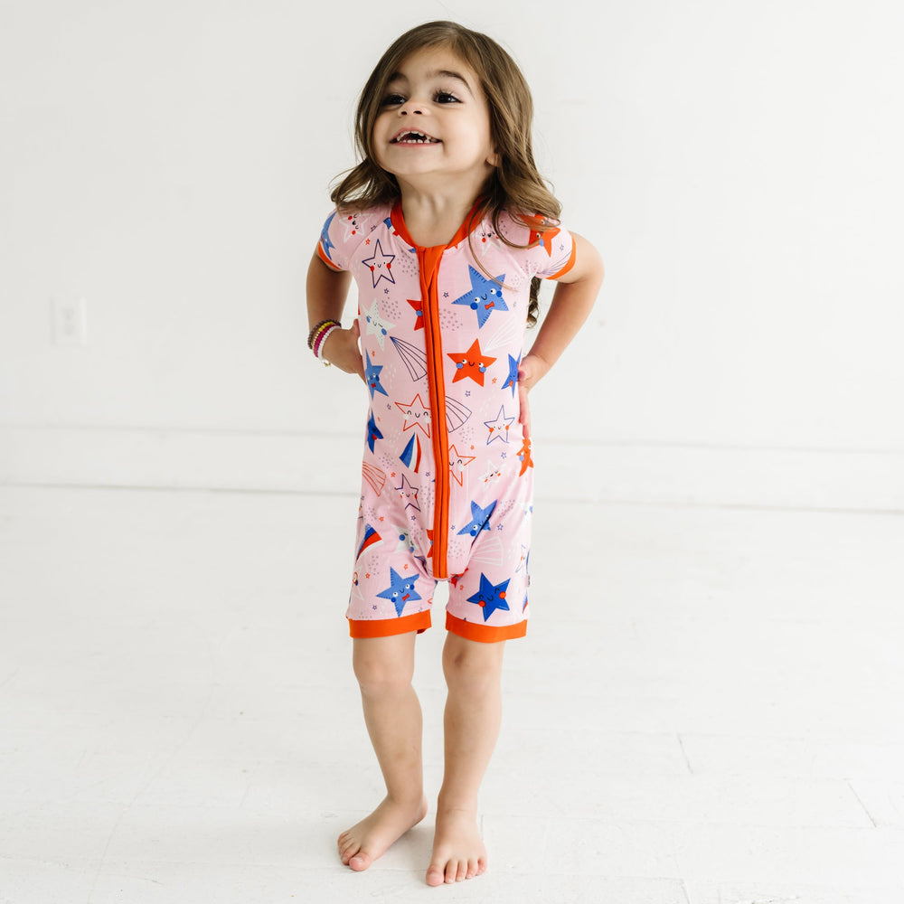 Child wearing a Pink Stars and Stripes printed shorty romper