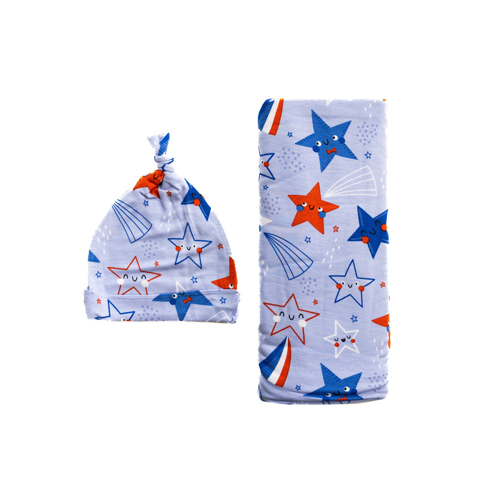 Flat lay image of Blue Stars and Stripes printed swaddle and hat set