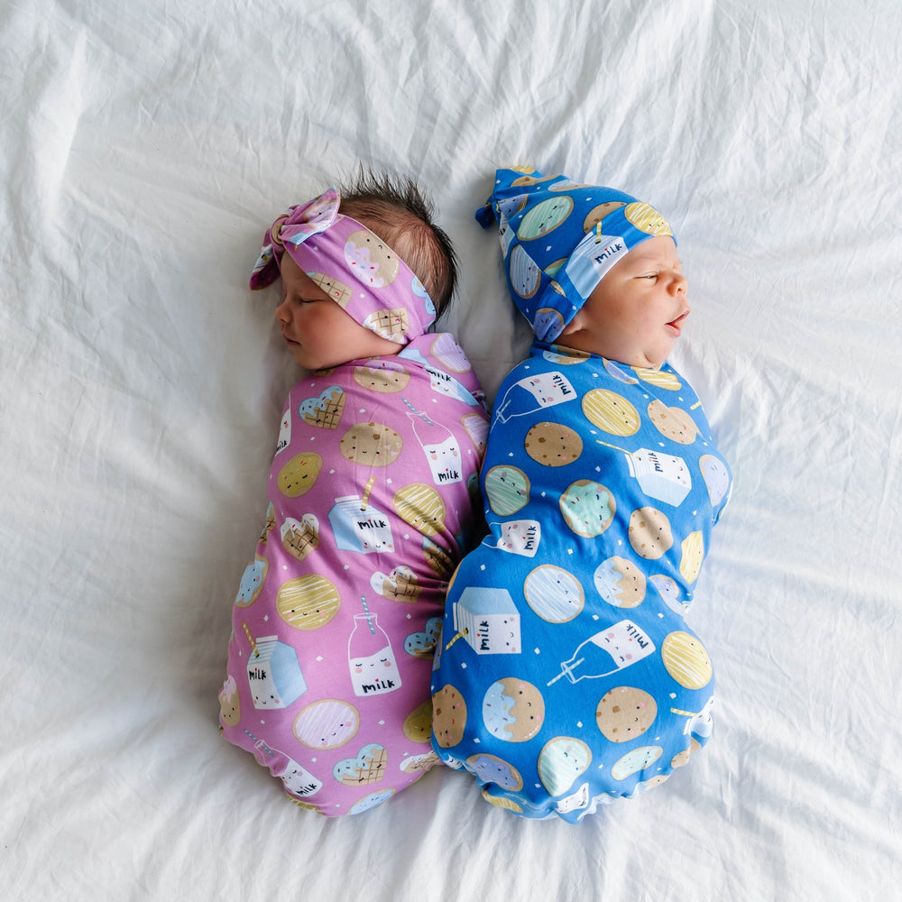 Children wearing matching Pink and Blue Cookies & Milk Swaddle sets