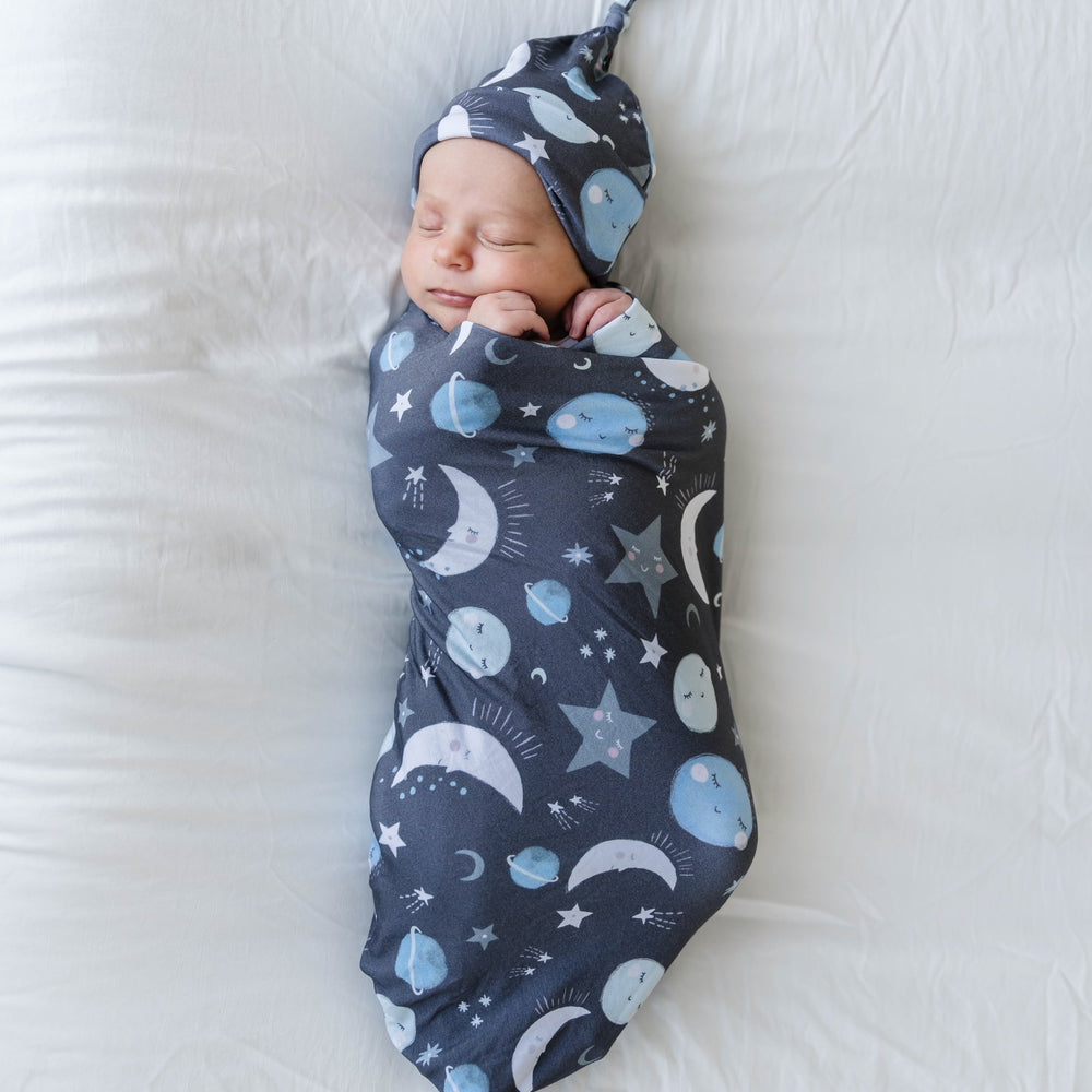 Click to see full screen - Infant in Blue To The Moon & Back Bamboo Viscose Swaddle + Hat Set