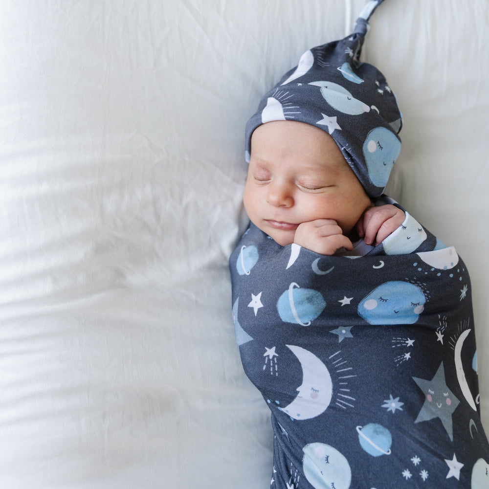 Infant in Blue To The Moon & Back Bamboo Viscose Swaddle + Hat Set
