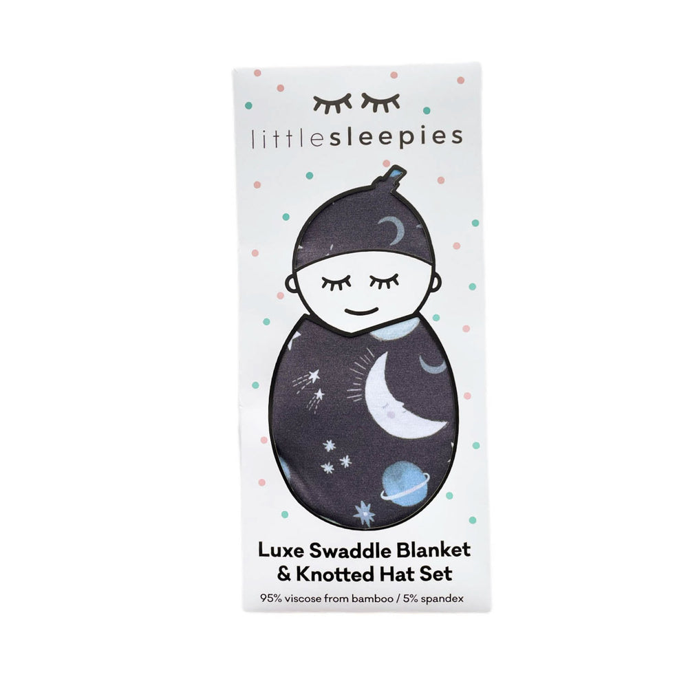 Click to see full screen - Image of Blue To the Moon & Back swaddle and hat set packaged in our signature peek a boo gift box 