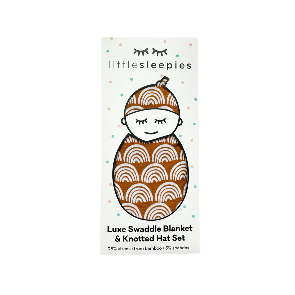 Image of Rust Rainbows swaddle and hat set packaged in our signature peek a boo gift box