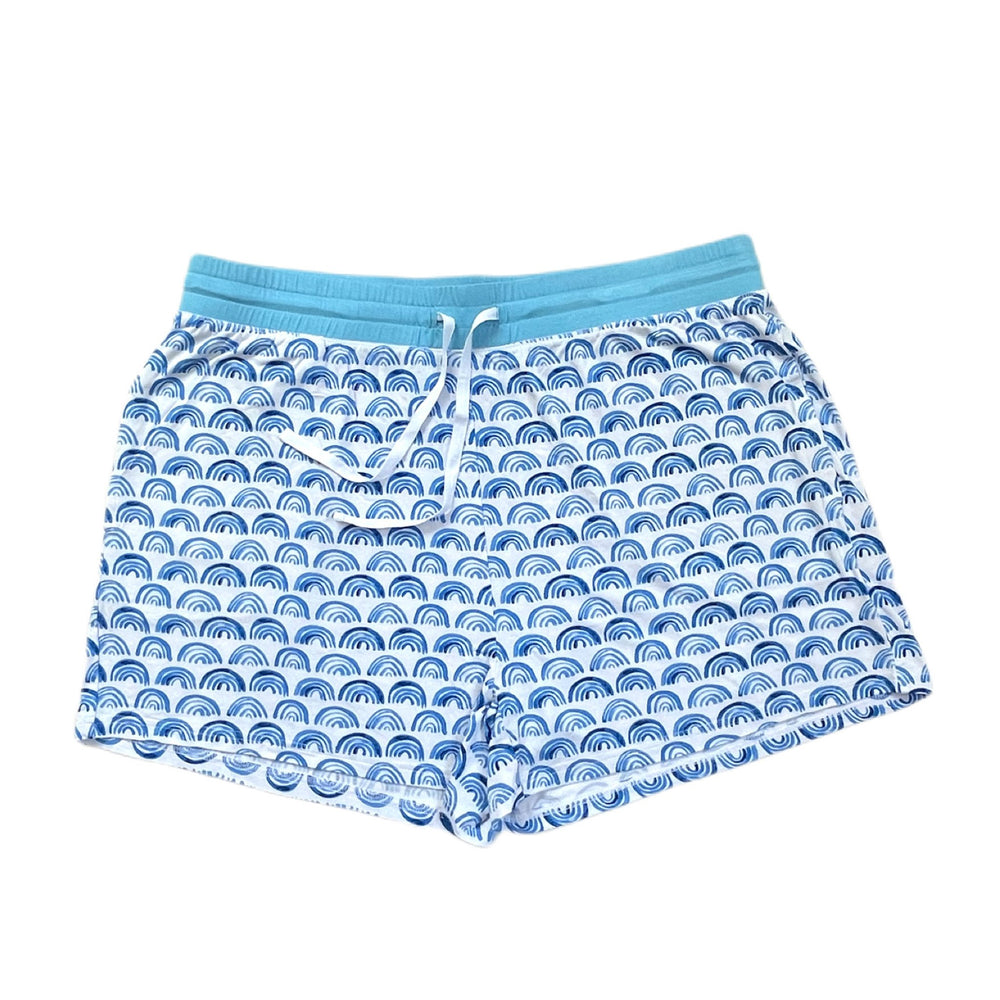 Flat lay image of women's pajama shorts in blue rainbows print. This print sits on a white background with shades of blue rainbows and sky blue trim details.
