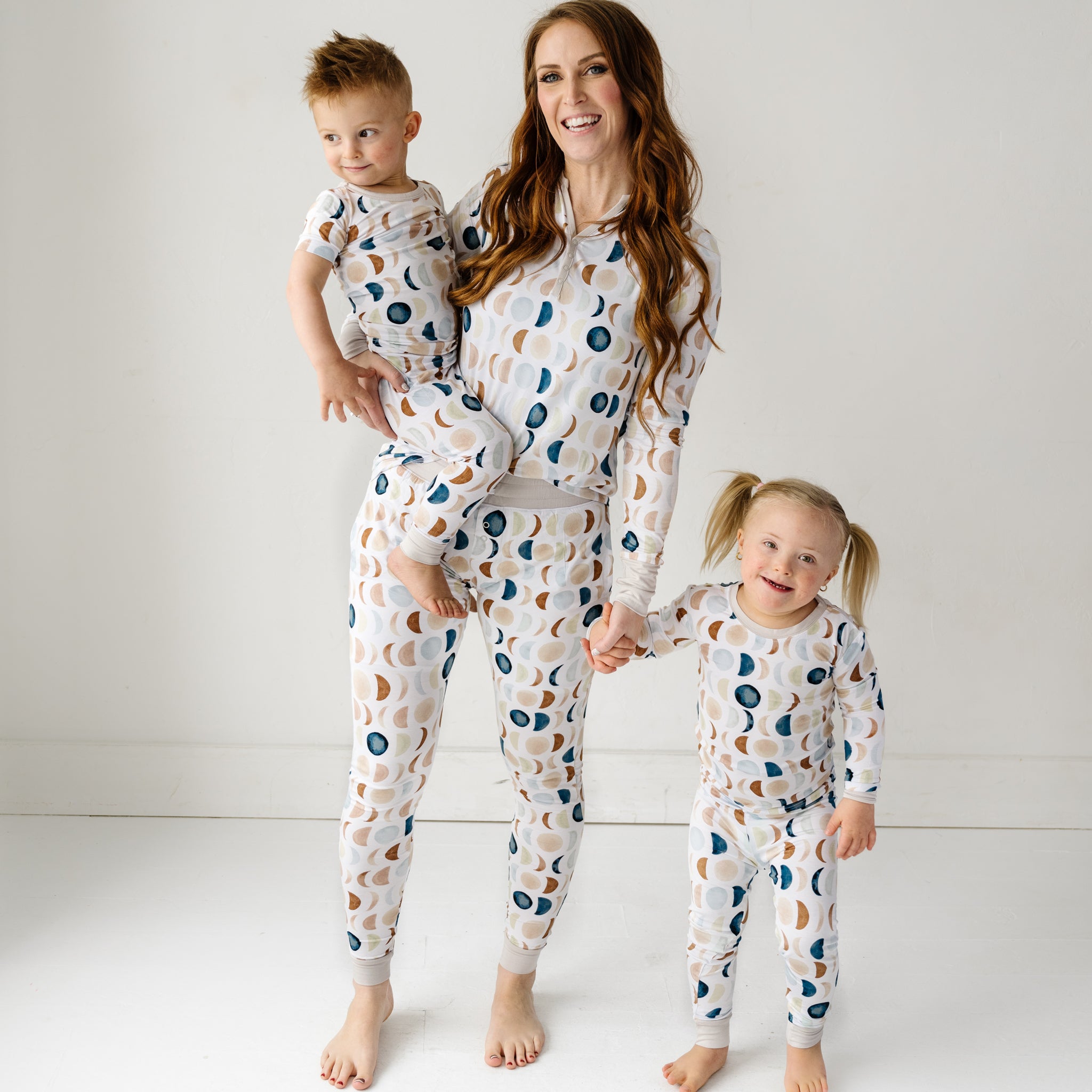 Mother and two kids wearing matching Luna Neutral Pajamas