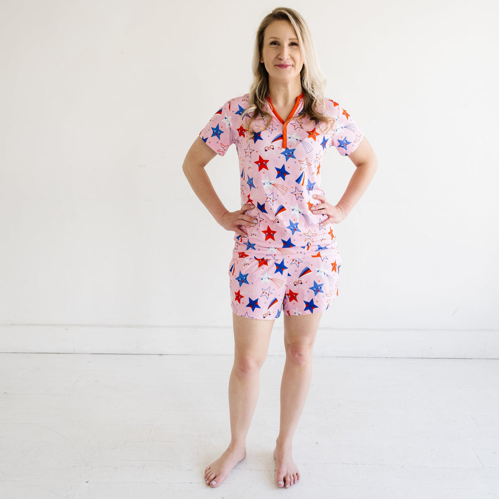 Woman wearing Pink Stars and Stripes printed women's pajama shorts paired with matching women's pajama top