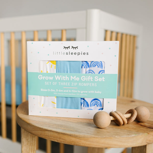 Blue Rainbows, Sky Blue & Sunshine Zippy Grow With Me Three Pack Gift Box on a wooden table