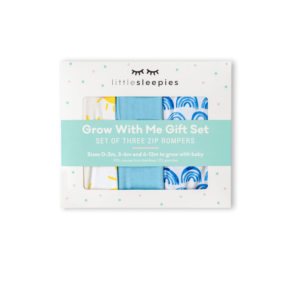 Image of Grow With Me gift box containing set of 3 zip up rompers in sunshine, solid sky blue, and blue rainbows