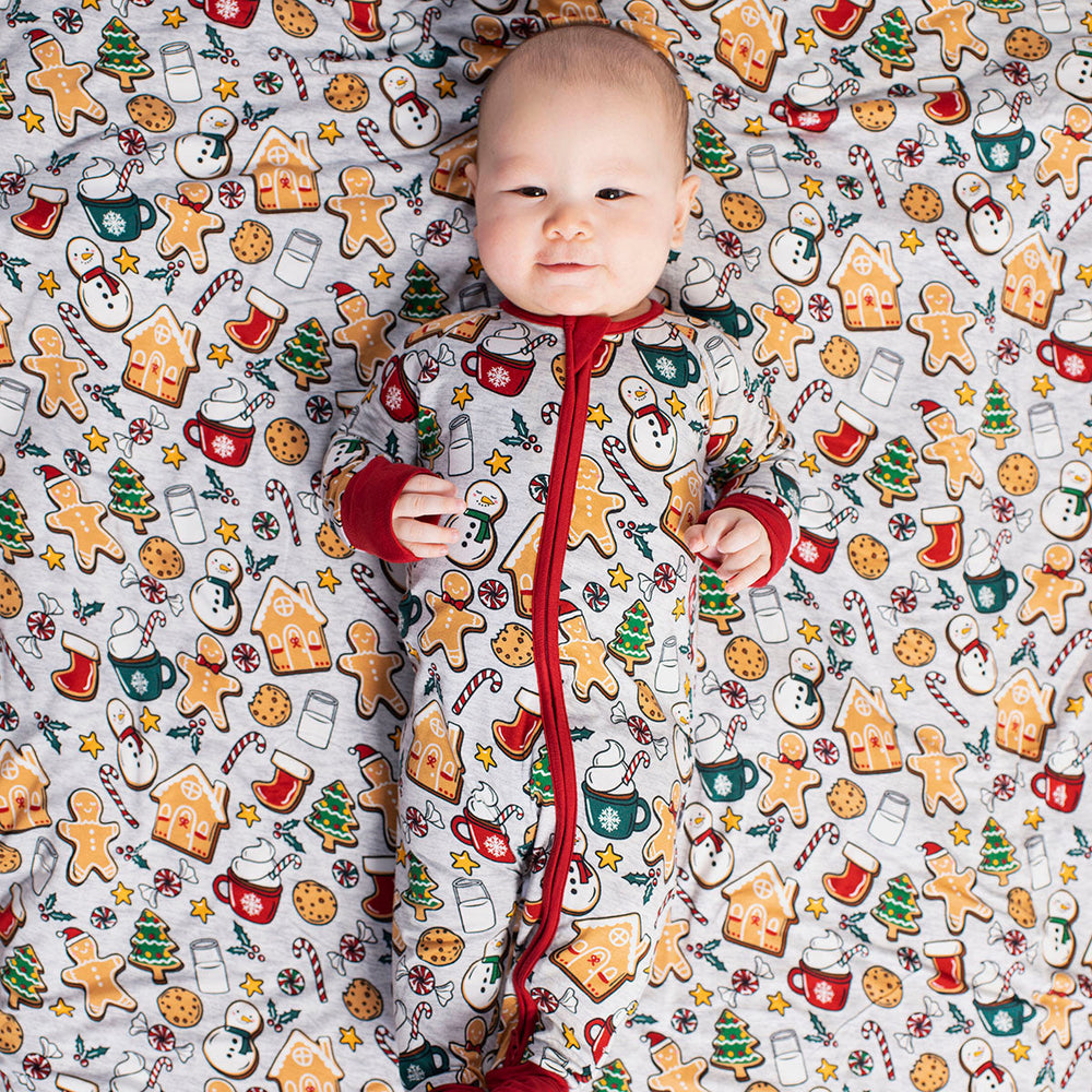child wearing a Holiday Treats zippy on a matching Holiday Treats cloud blanket
