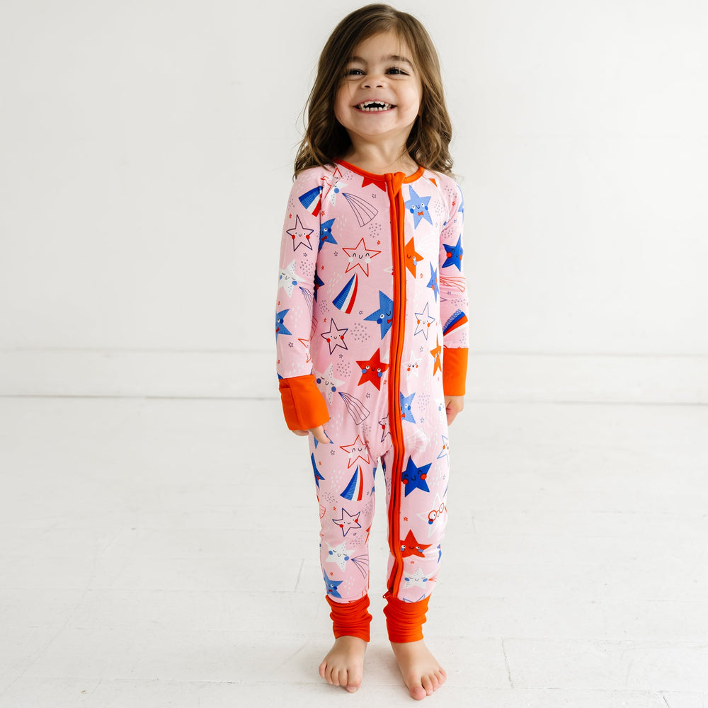 Child wearing a Pink Stars and Stripes printed zippy