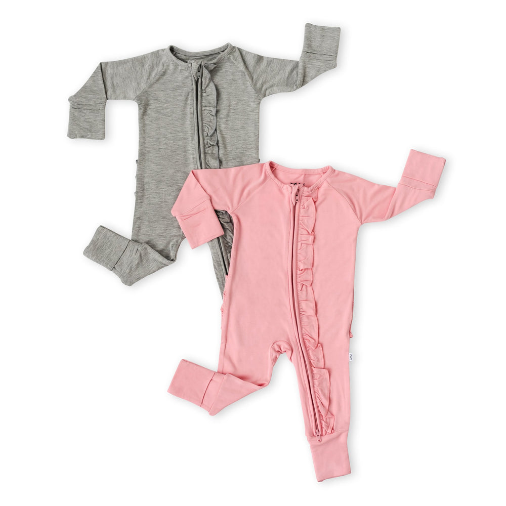 Click to see full screen - Flat lay image of set of 2 solid ruffle zip up rompers in heather gray and bubblegum pink. 
